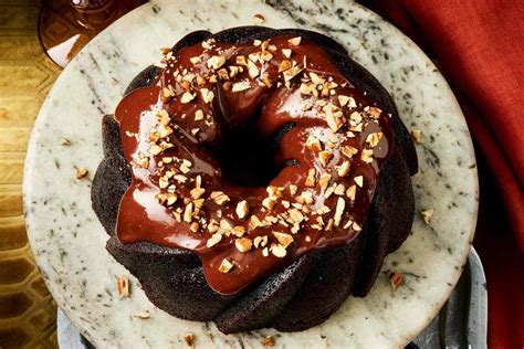 Thematic photo of a baked Bundt cake (šarkelj) with a chocolate glaze, garnished with pumpkin seeds