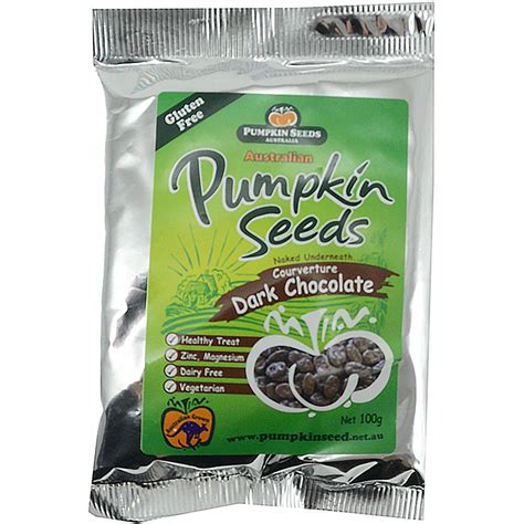 A close-up of a dark chocolate pumpkin seed cookie