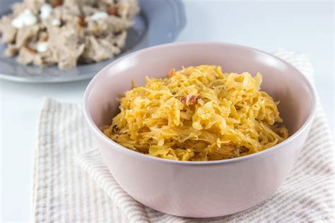 Sestavljena fotografija jedi: kuhano kislo zelje s kosi prekajene krače, postreženo v keramični posodi.