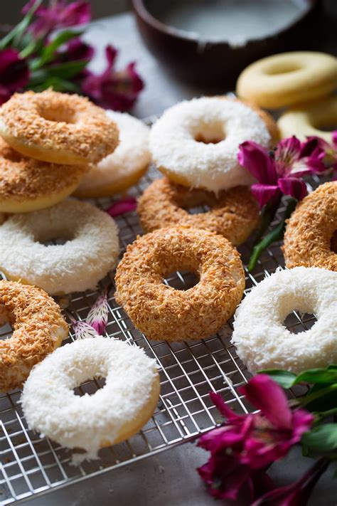 Thematic photo of various types of coconut donuts, some fried, some baked, with different toppings