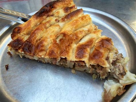 Thematic photo of a baked Serbian meat pie, sliced and ready to serve
