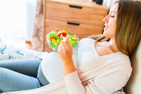 Thematic photo of a pregnant woman eating healthy food