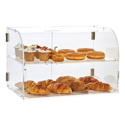 Thematic photo of a tabletop neutral display case with various types of bread and pastries