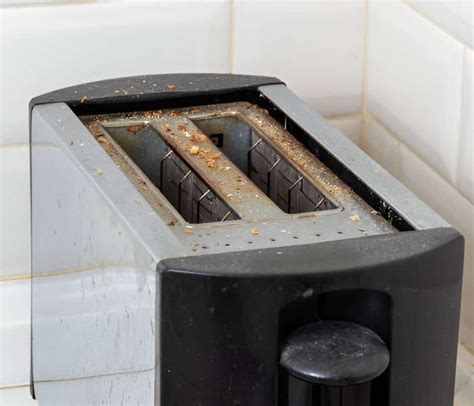 Thematic photo of a dirty toaster with food residues and a clean toaster