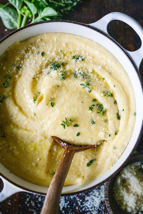 Thematic photo of creamy polenta with fresh herbs and cheese