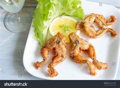 Thematic photo of fried frog legs on a plate