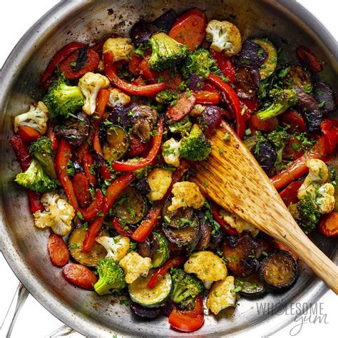 Photo of vegetables and rice being sautéed in a pan, before adding liquid.
