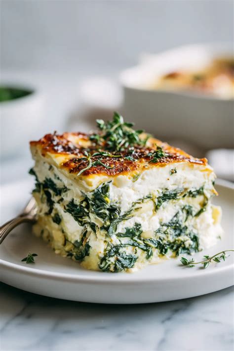 Photo of a slice of spinach and cottage cheese pie on a plate, showing the layers