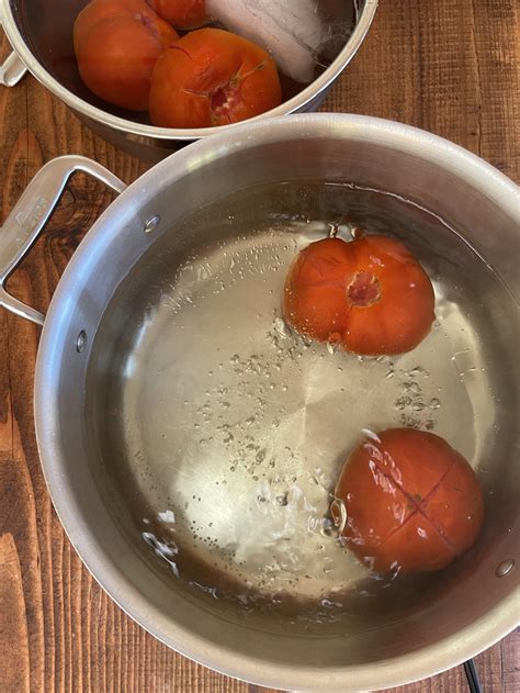 Close-up photo of blanching tomatoes in boiling water