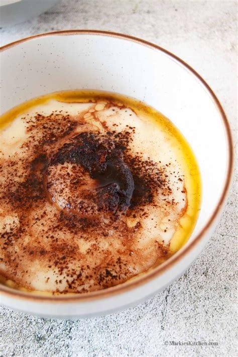A bowl of traditional semolina porridge with milk, sprinkled with cocoa