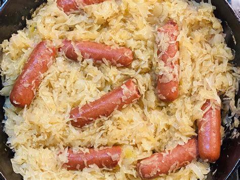 Thematic photo of cooked blood sausages served with sauerkraut and potatoes