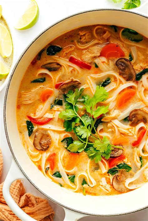 Thematic photo of a steaming hot Thai soup with noodles and various ingredients
