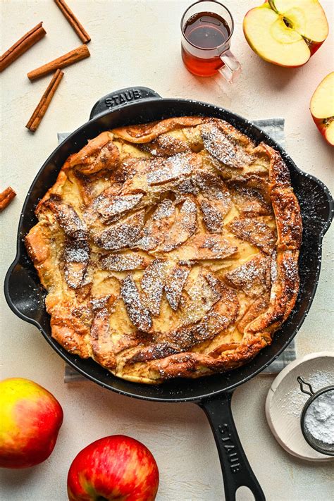 Photo of an apple pancake variation with caramelized apple pieces on top, dusted with cinnamon