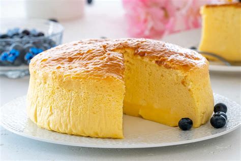 Puhast japonski cheesecake na pladnju, posut s sladkorjem v prahu