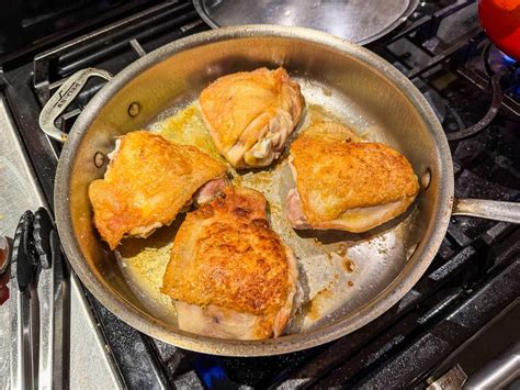 Close-up photo of chicken meat browning in a pan