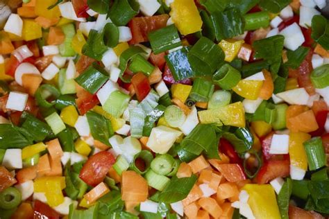Chopped vegetables (onion, carrot, bell pepper) and canned beans ready for cooking.