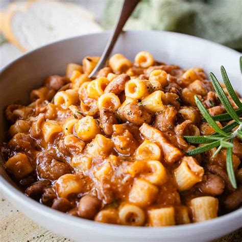 Traditional Italian household kitchen, showing a large pot simmering pasta e fagioli with dried beans.