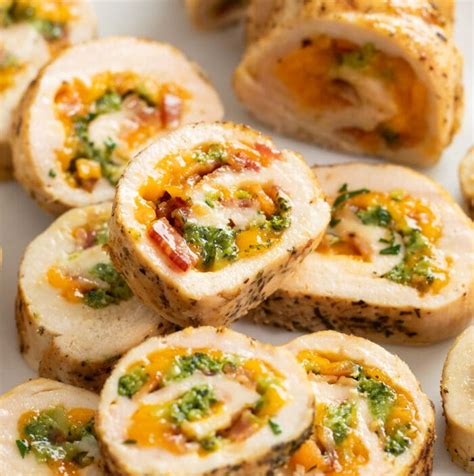 Thematic photo of chicken roulade with ham and cheese, served with sauce
