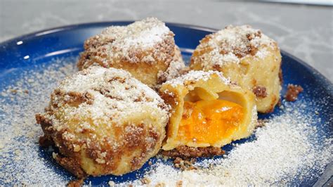 The finished apricot dumplings with quark dough, topped with browned breadcrumbs and powdered sugar.
