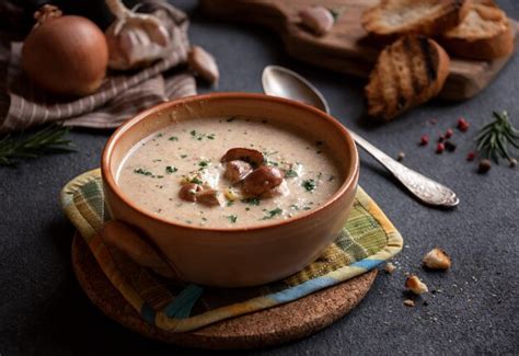 Thematic photo of creamy potato soup with porcini mushrooms and parsley.