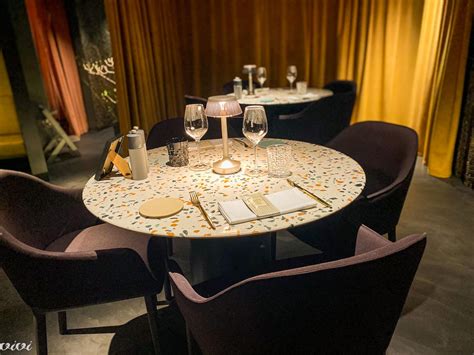 Elegantna restavracija s pripravljenimi mizami in sommelierjem, ki toči vino