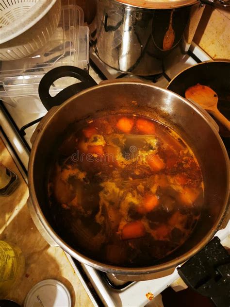 Thematic photo of a cozy kitchen with a pot of stew on the stove