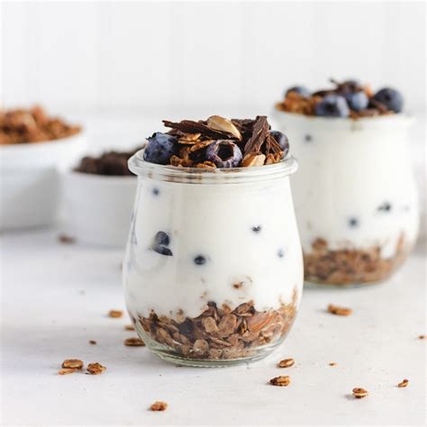 Različni dodatki, kot so sadje, oreščki, granola in chia semena, pripravljeni za dodajanje v jogurt