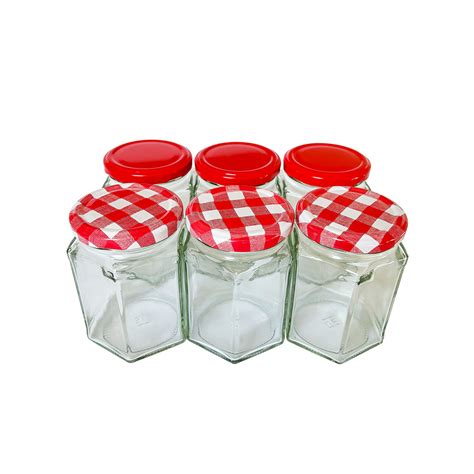 Ilustracija različnih metod polnjenja in zapiranja kozarcev za vlaganje češnjevega kompota.