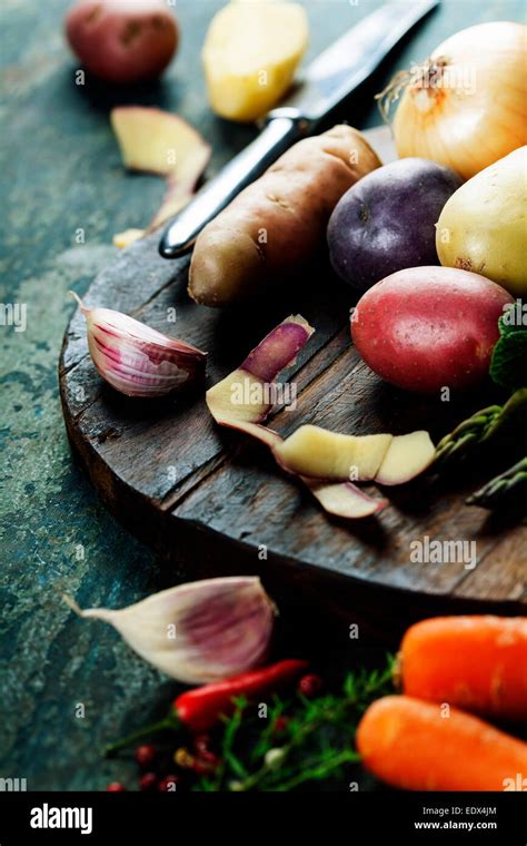 Thematic photo of young potatoes and fresh vegetables, ready for cooking