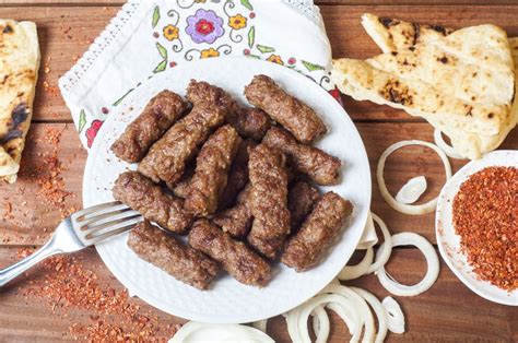Ingredients for cevapi, including minced meat, spices, and garlic