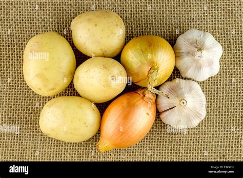 Photo of ingredients for garlic soup: garlic, onion, potato, stock cube, herbs.