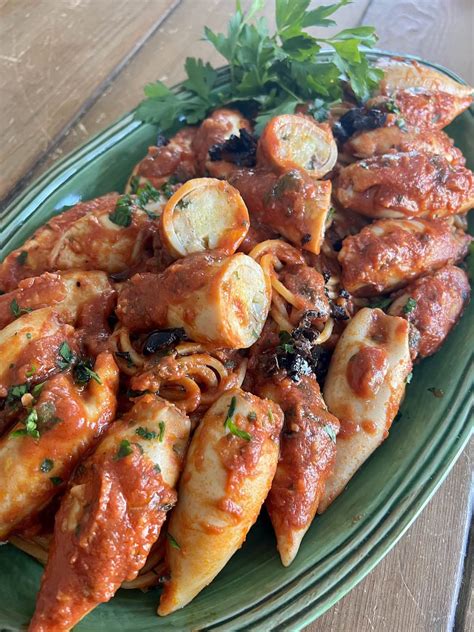 Thematic photo of stuffed squid on a plate with Mediterranean herbs