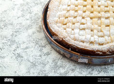 Thematic photo of a slice of fruit biscuit with powdered sugar