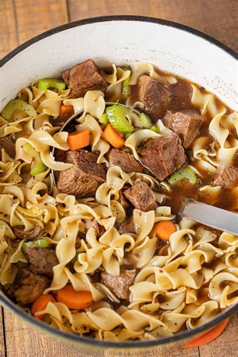 Thematic photo of a classic homemade beef soup with noodles, meat and vegetables