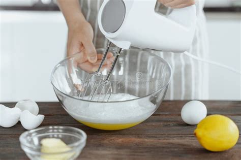 Image of an electric mixer whisking eggs and sugar until light and fluffy.