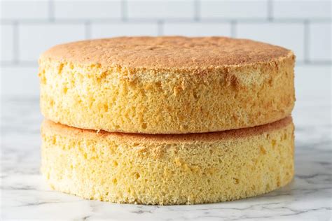 The image should show a sliced cake with visible layers, including a cake sponge, and perhaps some nuts or cocoa powder in the sponge.