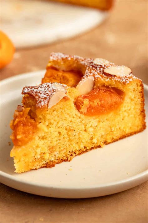 Thematic photo of a slice of sponge cake with sour cream and apricot jam