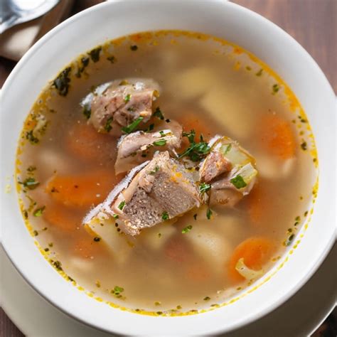 Thematic photo of a bowl of traditional Slovenian sour pork soup with bread