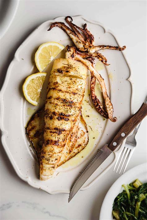 Themed photo of grilled squid on a plate with side dishes, Mediterranean style