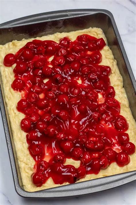 The process of making a cherry and mascarpone pie, showing the dough, filling, and cherries