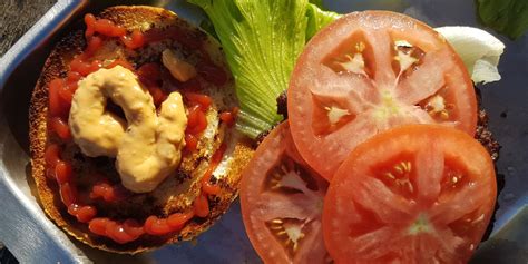 Klasična burger omaka v posodici, posuta s svežim drobnjakom