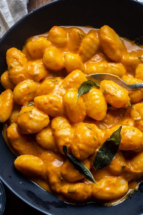 Thematic photo of pumpkin gnocchi with a sauce, possibly with sage or chives