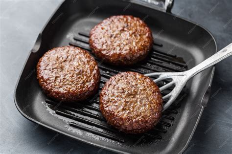 Thematic photo of beef patties being cooked in a pan