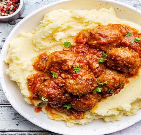 Thematic photo of meatballs in tomato sauce with mashed potatoes