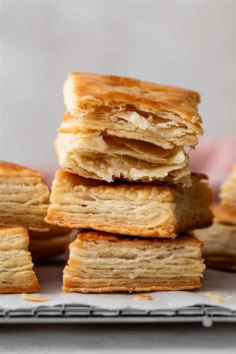 Photo of golden-brown baked puff pastry rolls on a baking sheet