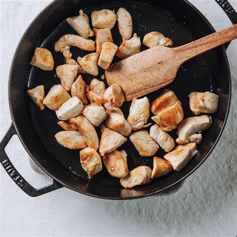 Step-by-step photo of chicken pieces browning in a pan