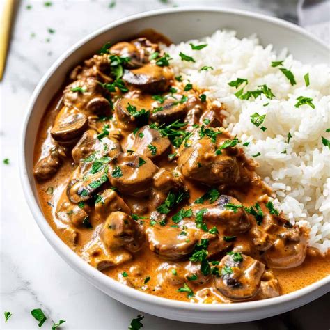A bowl of chicken Stroganoff with mushrooms and sour cream, served with rice