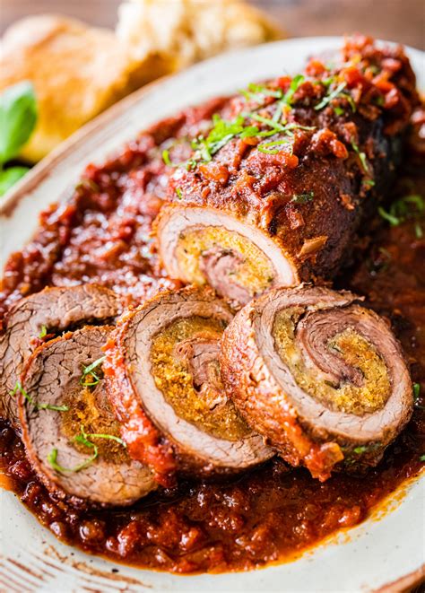 Thematic photo of a perfectly cooked stuffed beef roll, sliced to show the filling