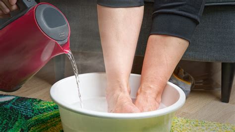 Thematic photo of feet soaking in a warm foot bath with natural ingredients