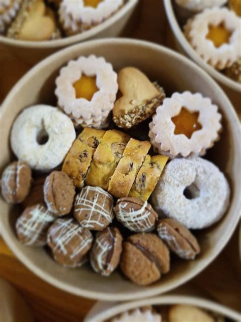 Fotografija sveže pečenih, zlato obarvanih krhkih piškotov na pekaču.